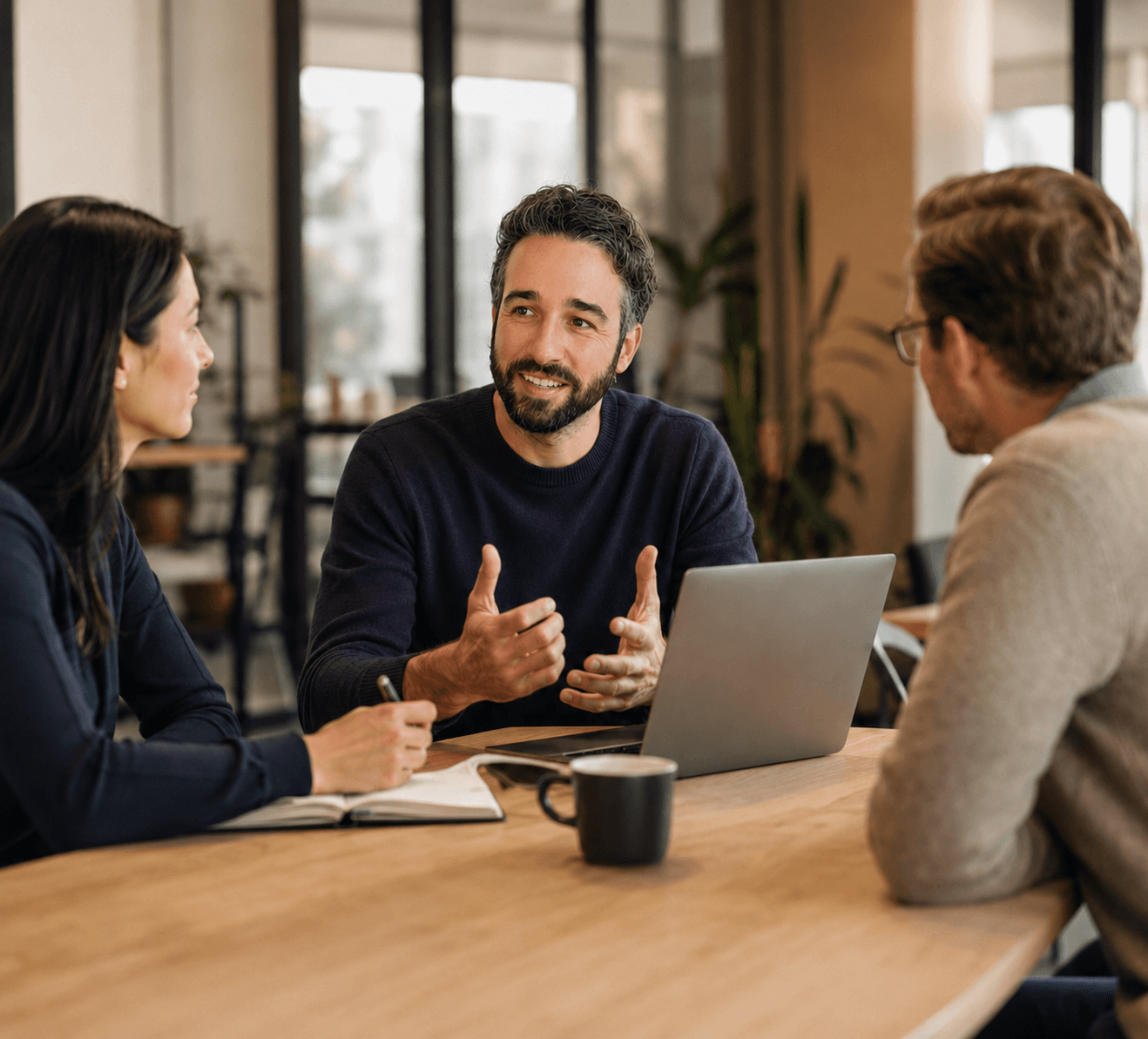 Three colleagues discussing a business priority in a workshop